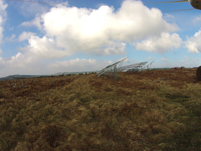 The panels and test area from the ground, showing the grassland and the dense 'thatch' that has built up over the years which impedes the growth of more sensitive species.