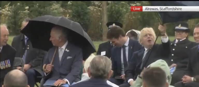 Boris Johnson gives a demonstration on how to put up an umbrella