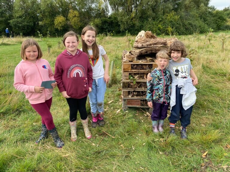 Local children create giant bug hotel at Community Woodland