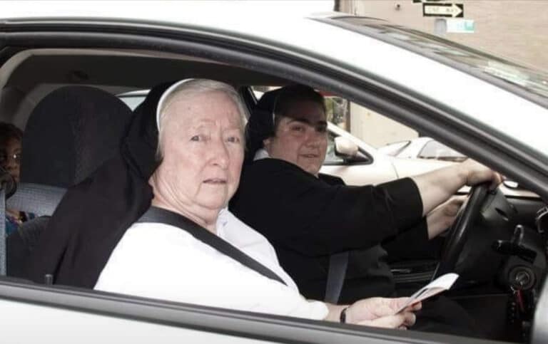 A car load of drunks pulls up next to some nuns at a traffic light