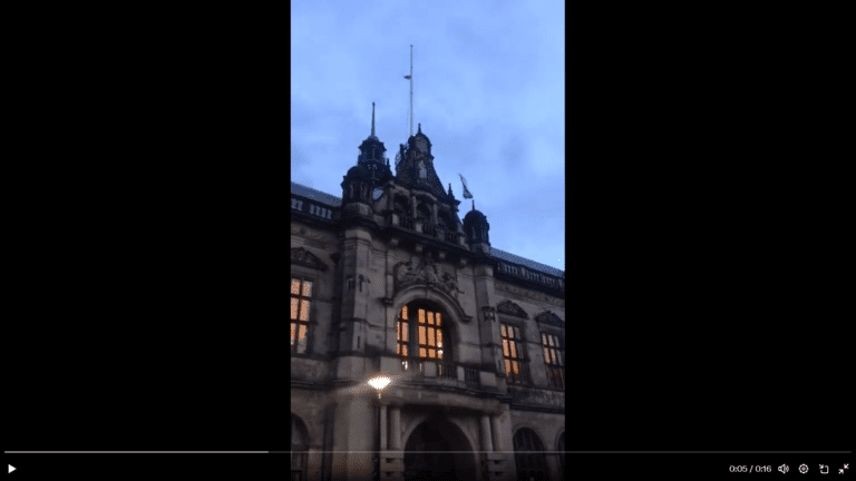 Man removes the flag of apartheid, terrorist state and replaces with a symbol of freedom